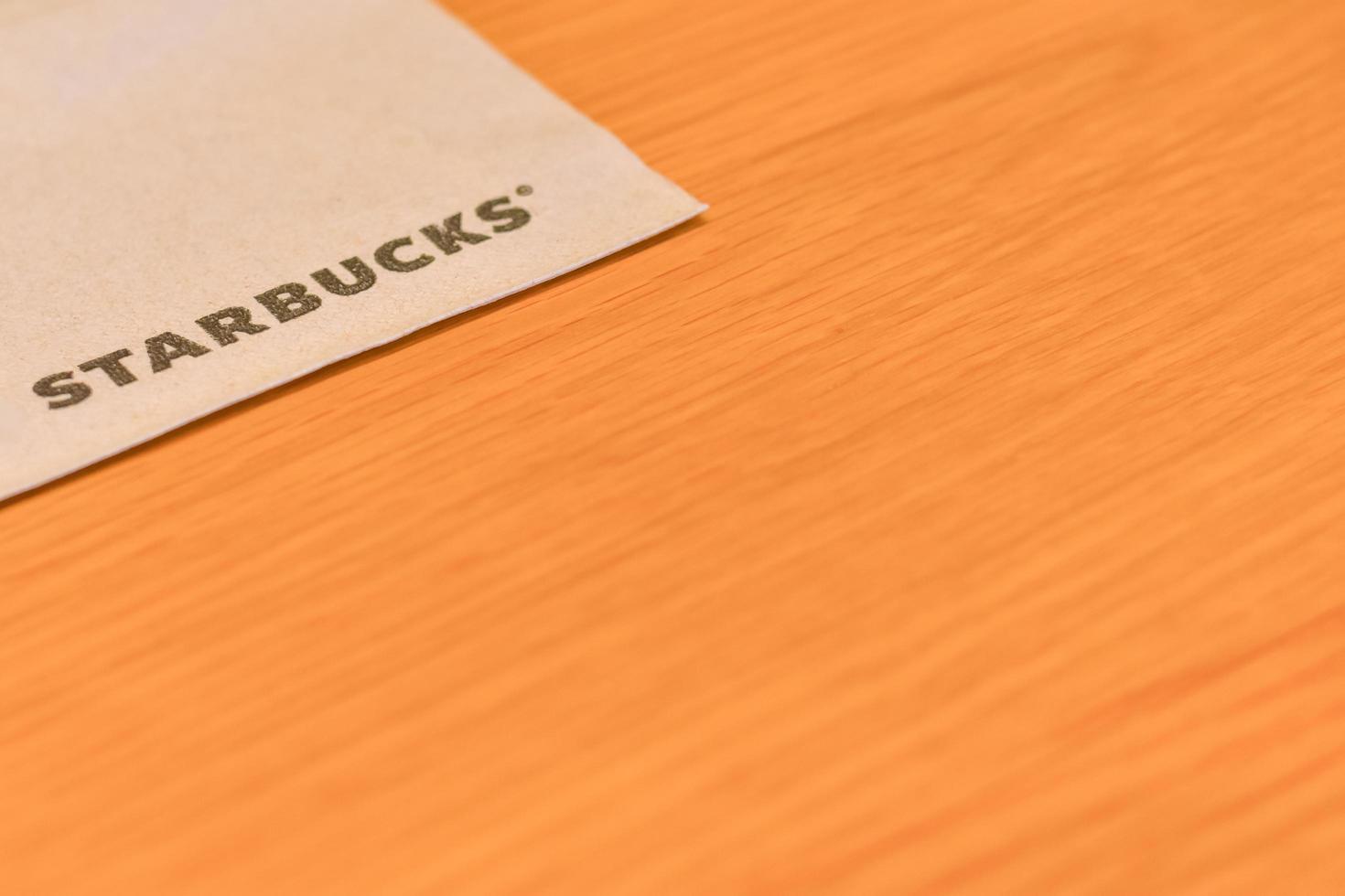 Bangkok, Thailand . July 7, 2021. Starbucks tissue paper on a wooden table. Selective focus. photo