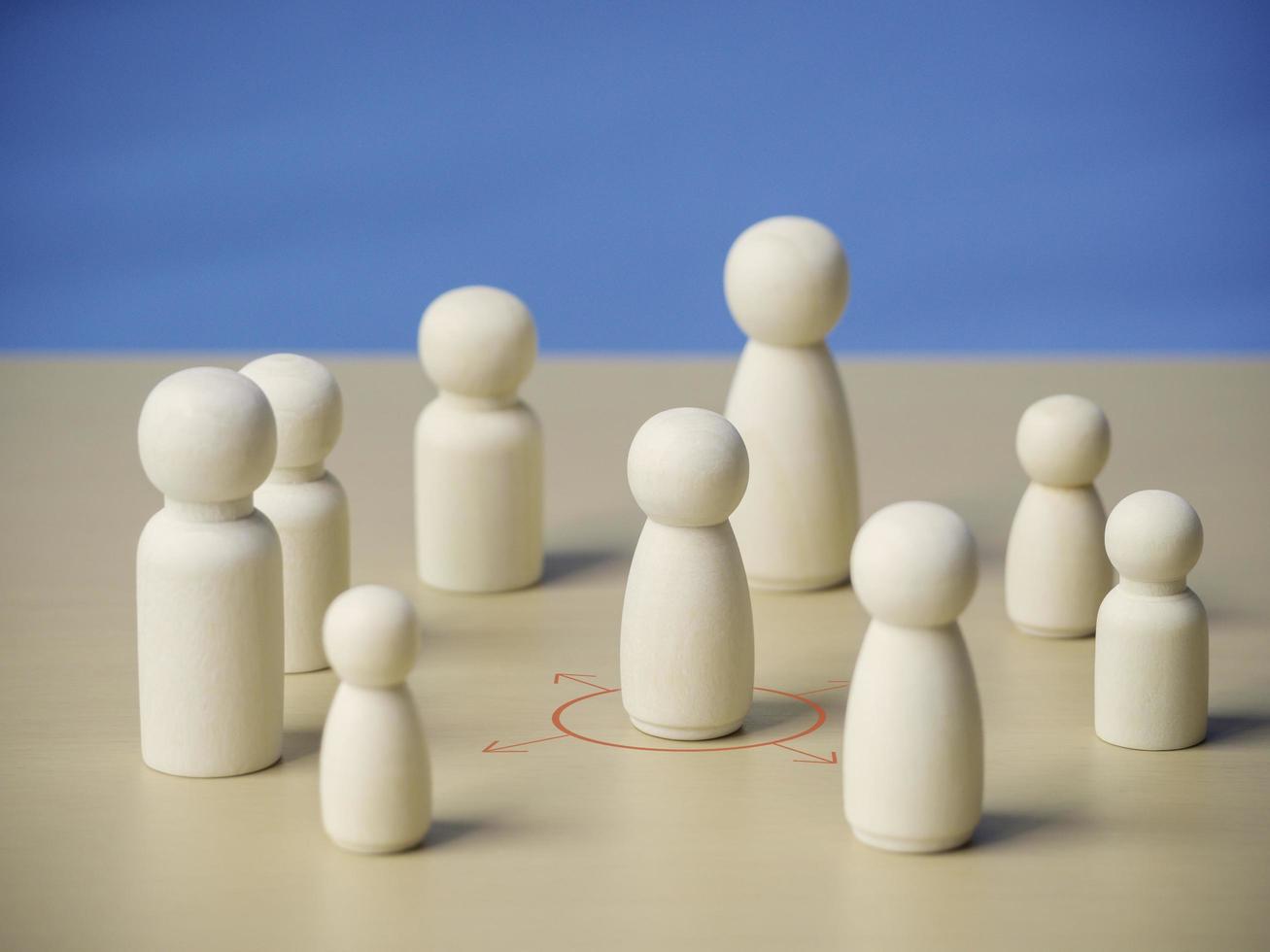 Wooden figure standing in red and arrow cycle showing social distancing concept prevention and protection from Coronavirus or COVID-19 outbreak spreading.Social and Physical distancing. photo