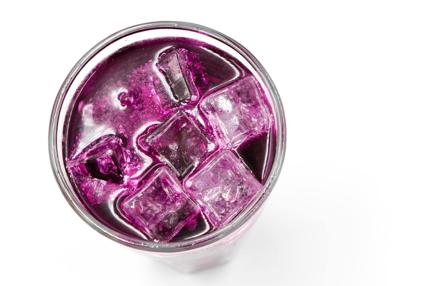 Grape sparkling water with Ice in glass over white background. photo