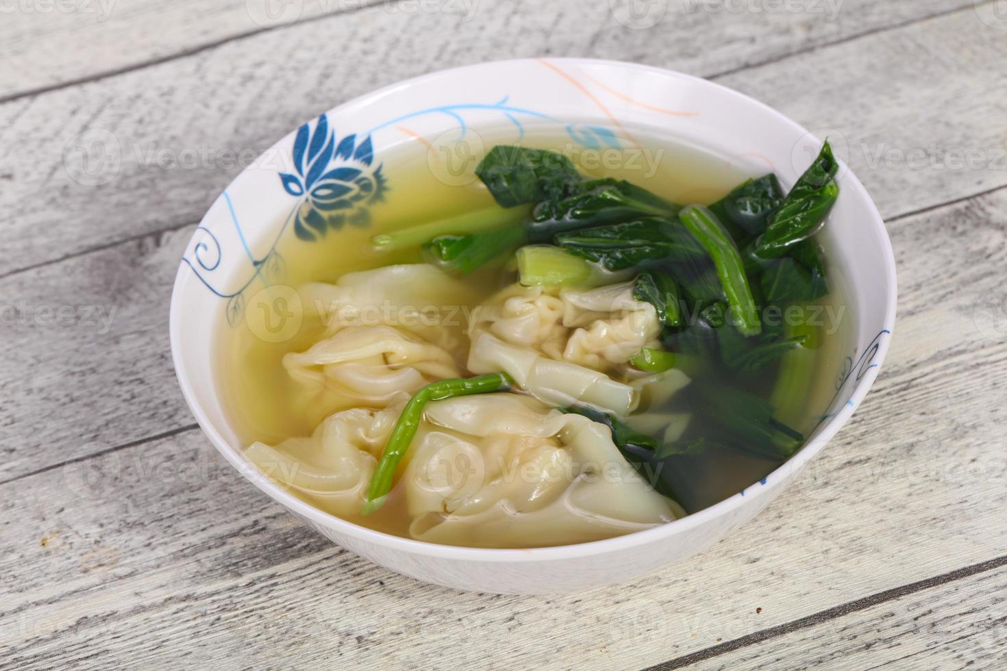Asian traditional Wonton soup with herbs photo