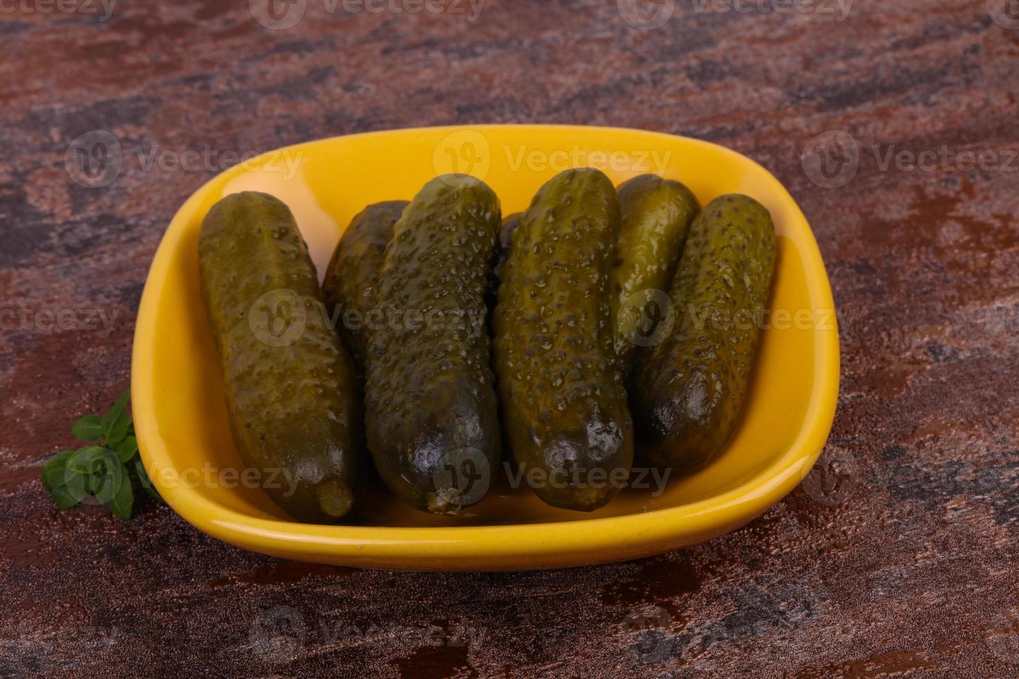 Pickled cucumbers heap in the bowl photo