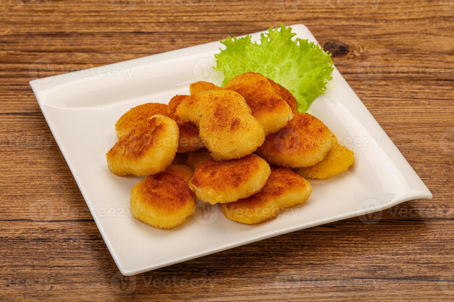 Fried chicken nuggets served salad leaves photo