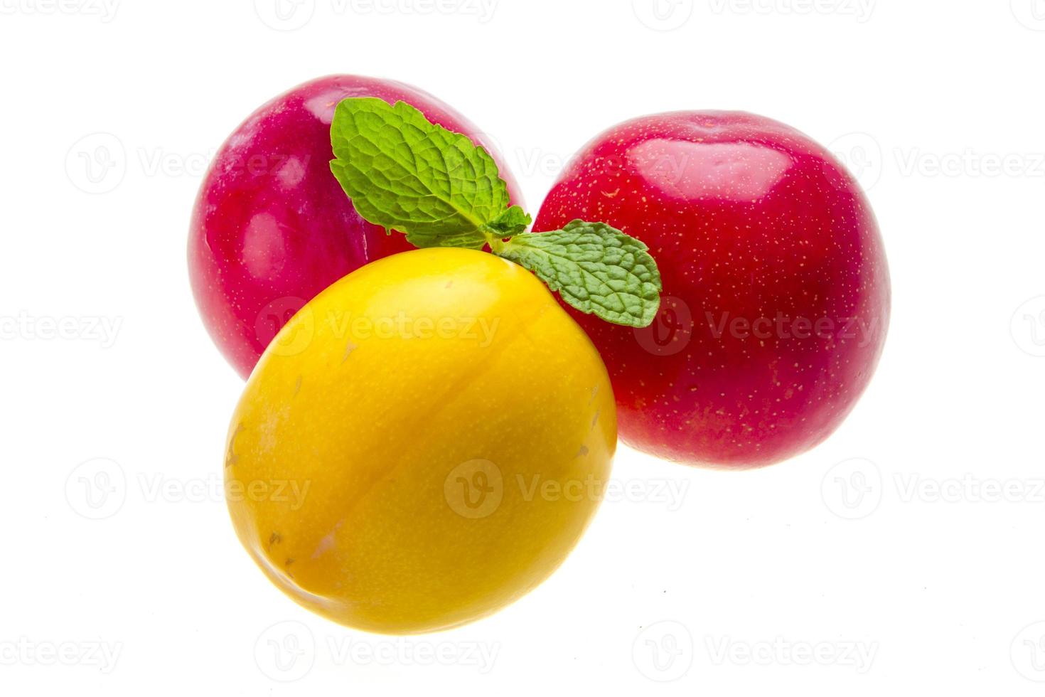 Bright ripe plum with mint photo