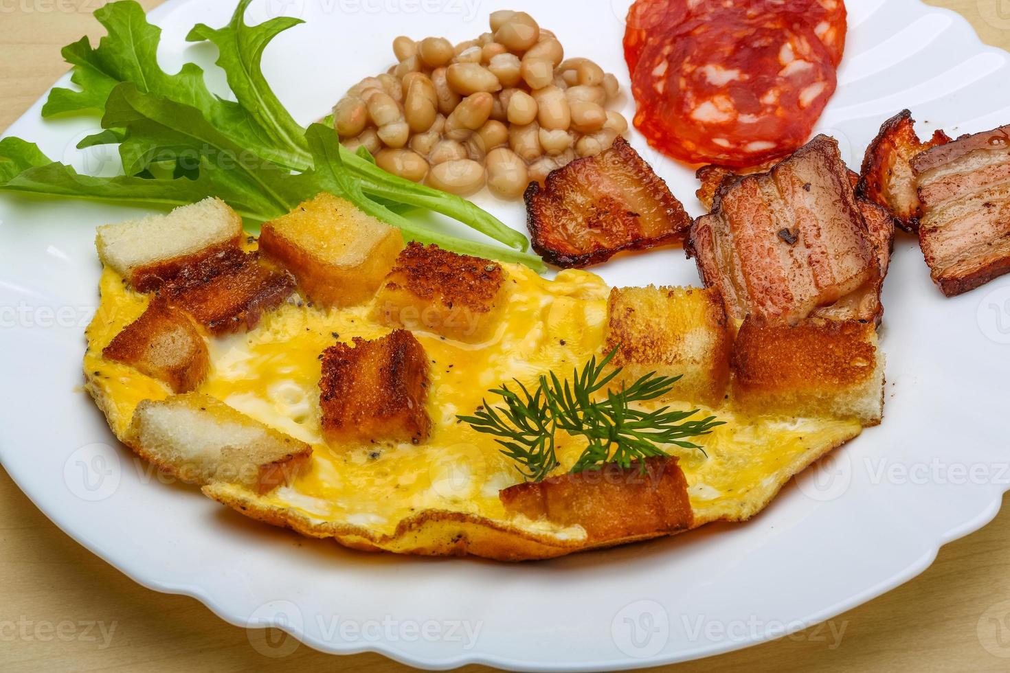 Breakfast with eggs, bacon and beans photo