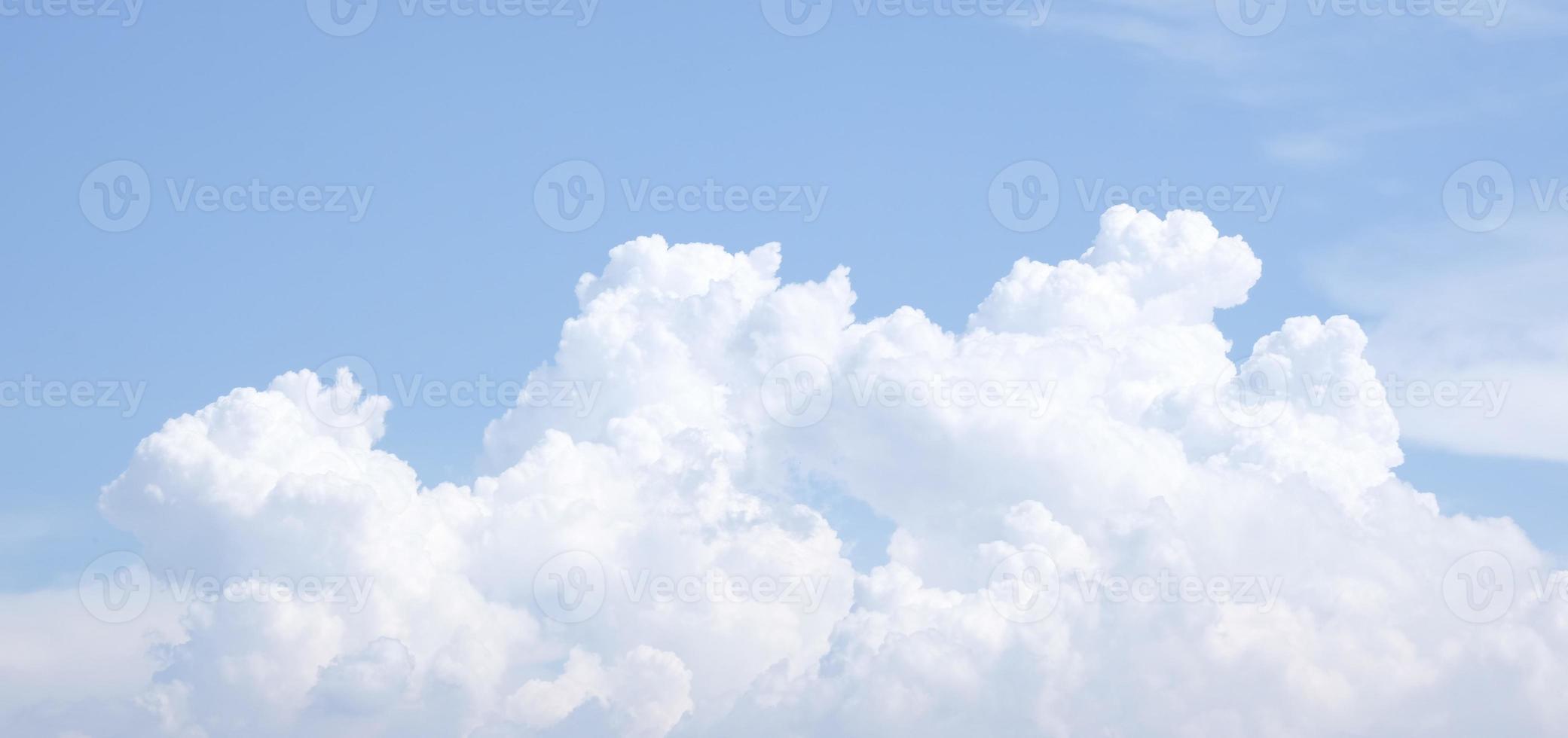 Bright blue sky with white fluffy clouds photo