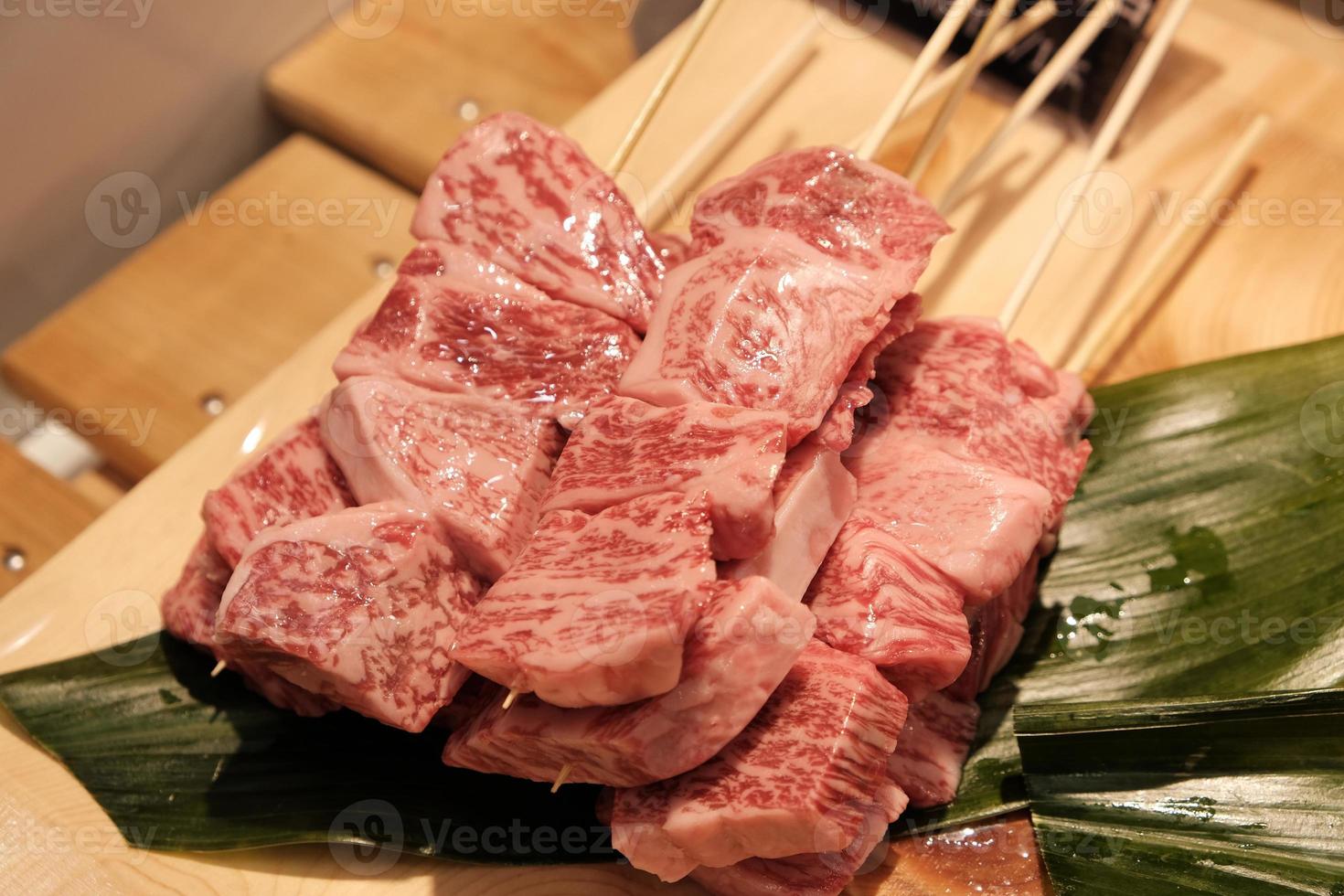 A5 beef sticks on wood tray with green leave decoration photo