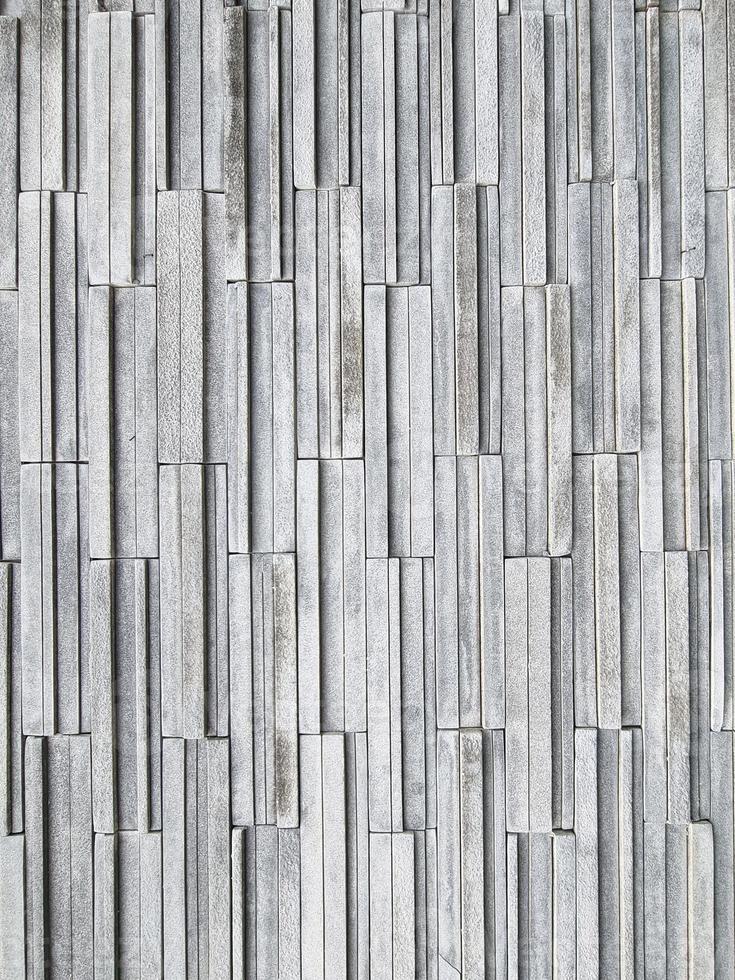 Luxury multi layer brick vertical line square shape gray color. strong brickwork wall outdoor house rock. photo