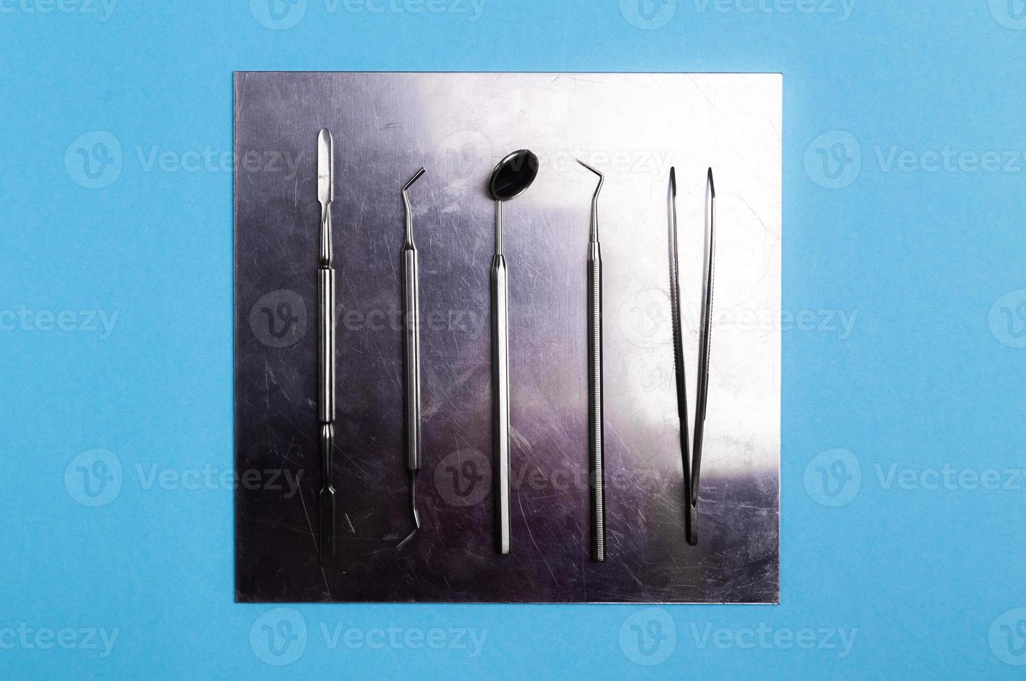 Dentist tools and artificial jaw on bright yellow and violet background. photo