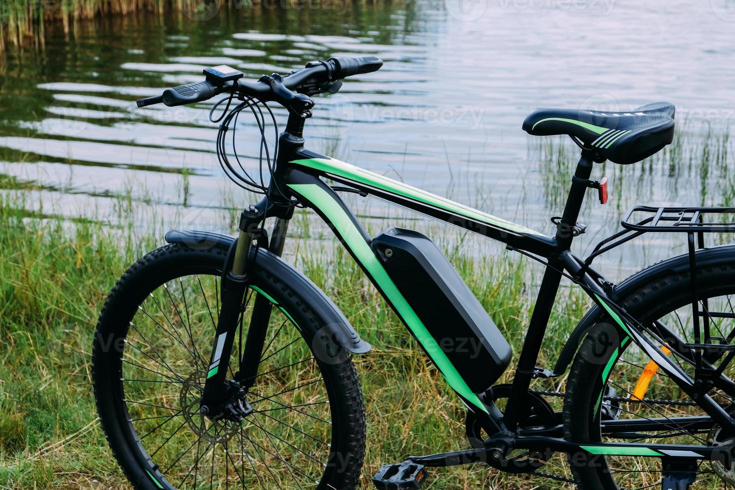 E-bike in the park in summer day. The view of the e motor and power battery. photo