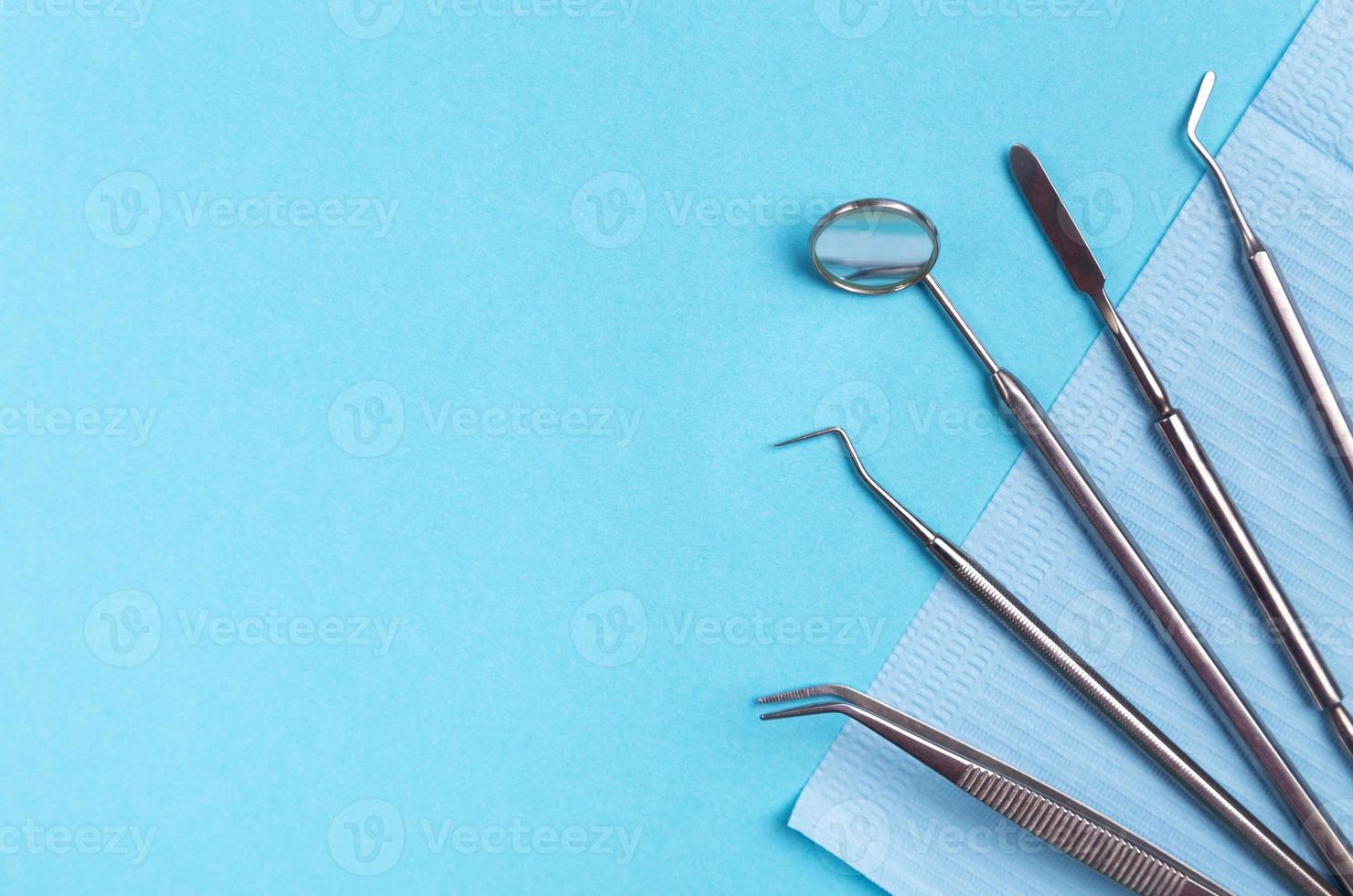 Dentist tools and artificial jaw on bright yellow and violet background. photo