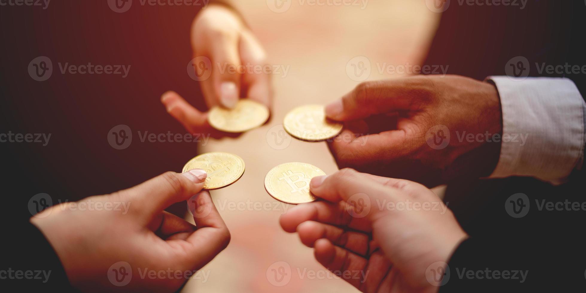 Close-up photo of Bitcoin, business people holding coins together Cryptocurrency Market Trends Bitcoin Stock Growth Investing in Virtual Assets investment platform Investing in today's world