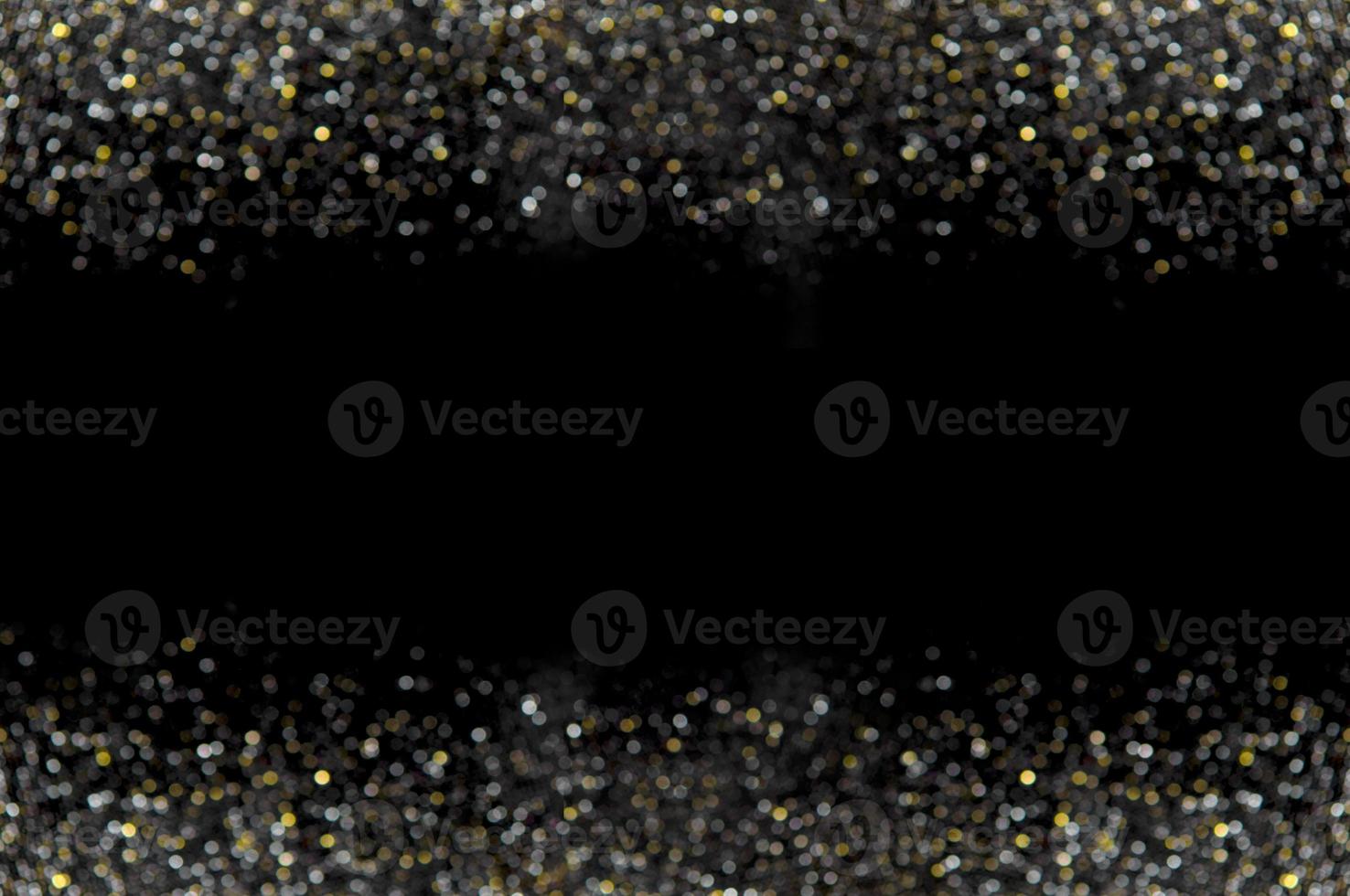 Black background with gold and silver sparkles. photo