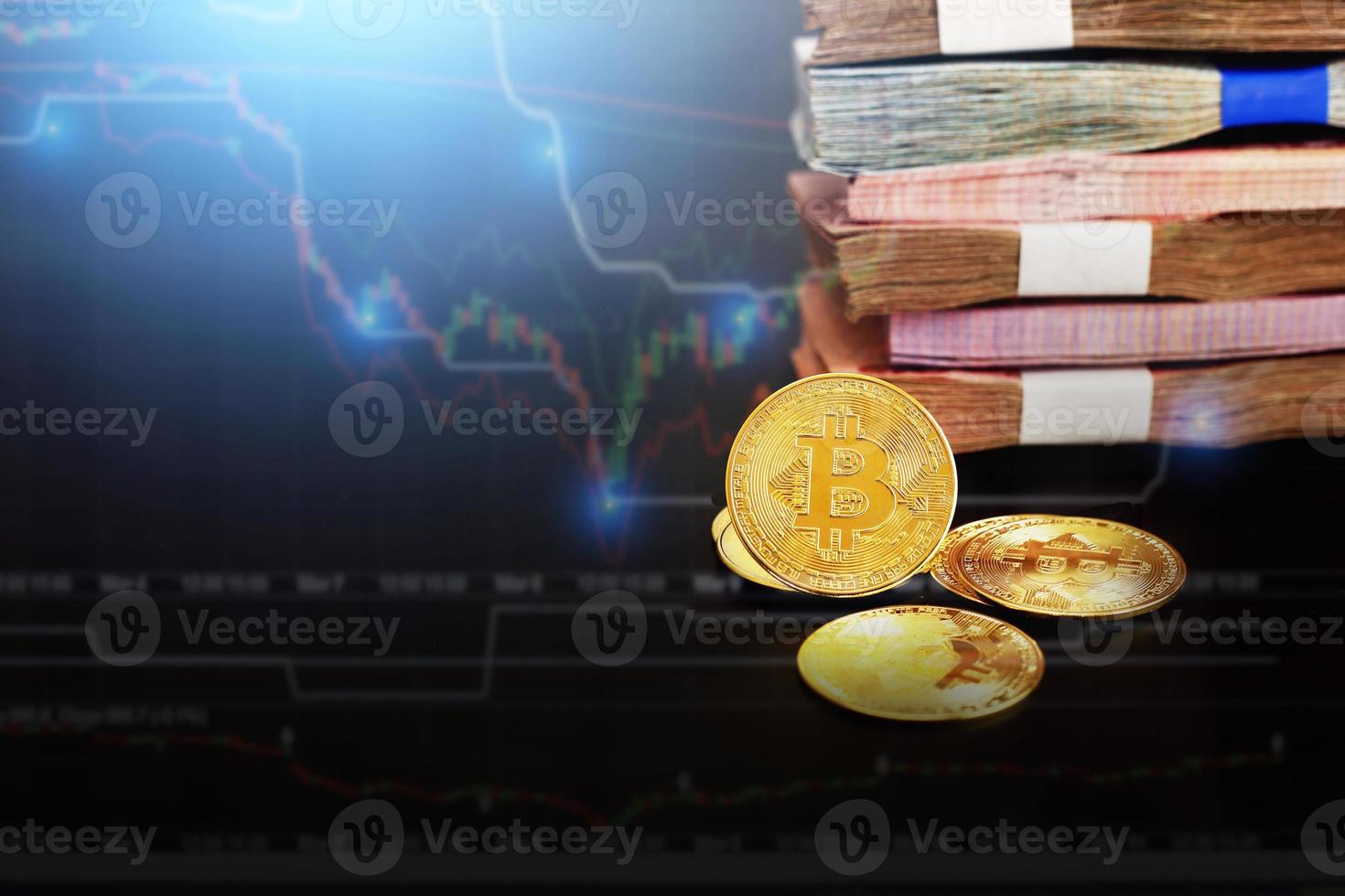 Cryptocurrency symbol with  copy space. The shiny bitcoin gold coin stands out in front of other coins and many banknote with forex growth graph. photo