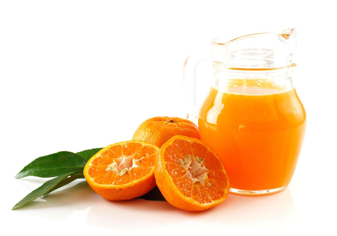 Jug of fresh orange juice against white background photo