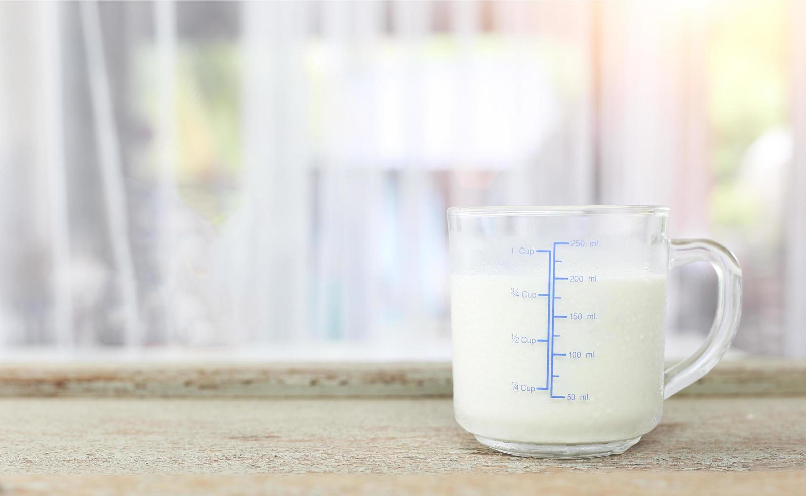 World milk day concept - Glass of fresh cold rustic cow milk - high protein and calcium on a wooden table for breakfast in the morning. photo