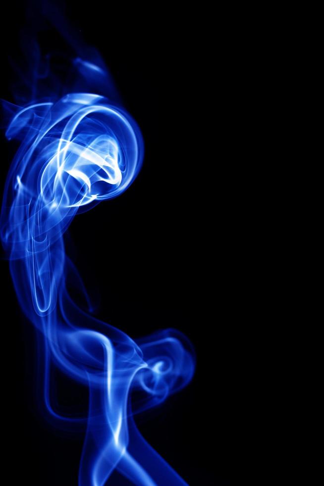 Blue smoke on black background photo