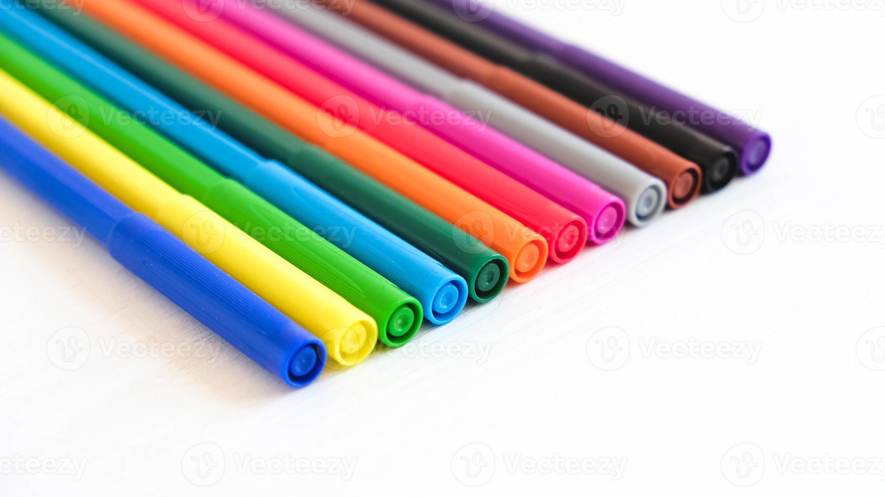 Multicolored felt-tip pens on a white background photo