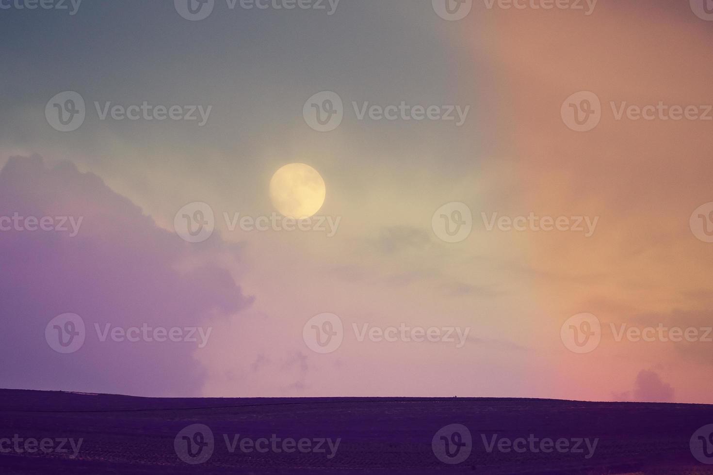 Fantastic fairytale landscape with the moon over a lavender field photo