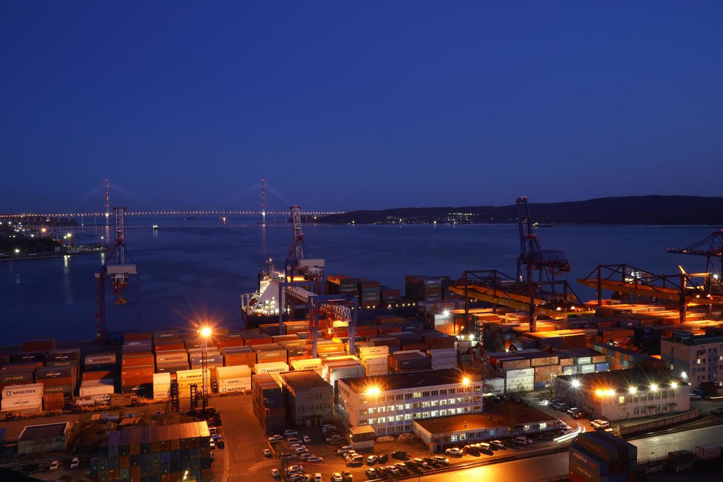 Vladivostok, Russia - March 28, 2020-Night landscape overlooking the port and Russian bridge photo