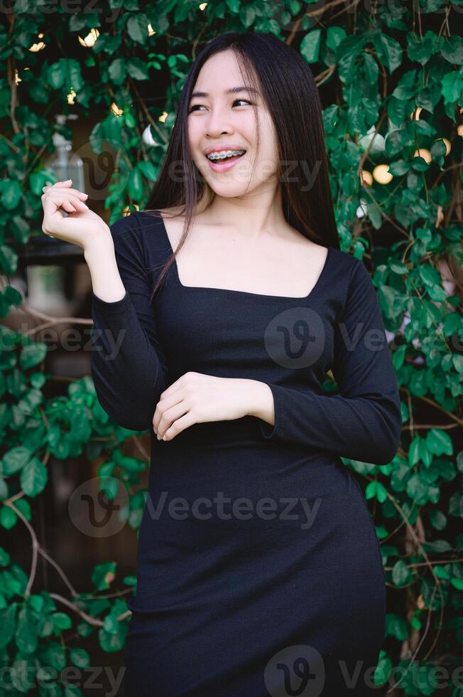 A woman in a black dress smiling photo