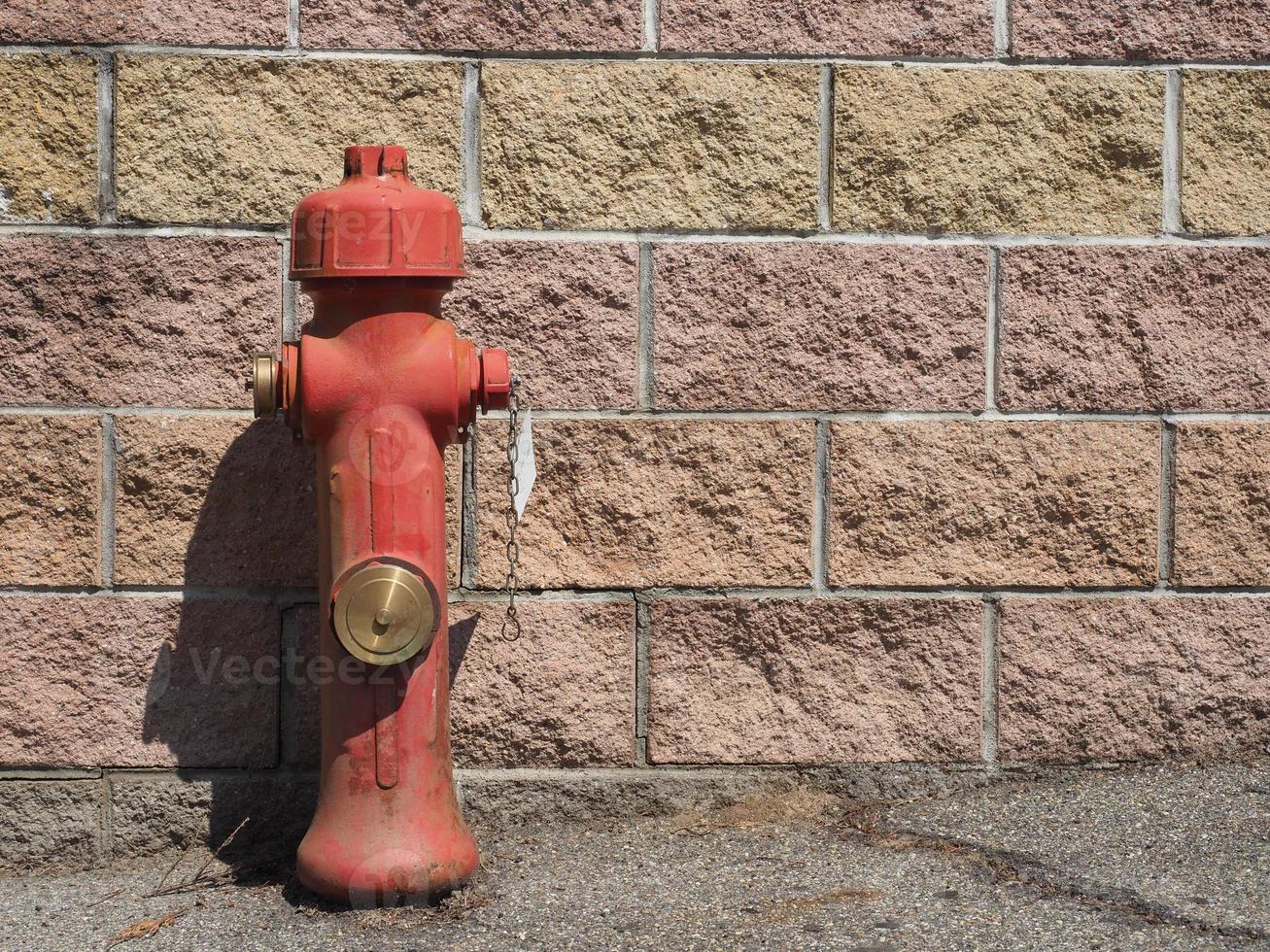 fire hydrant before a wall photo