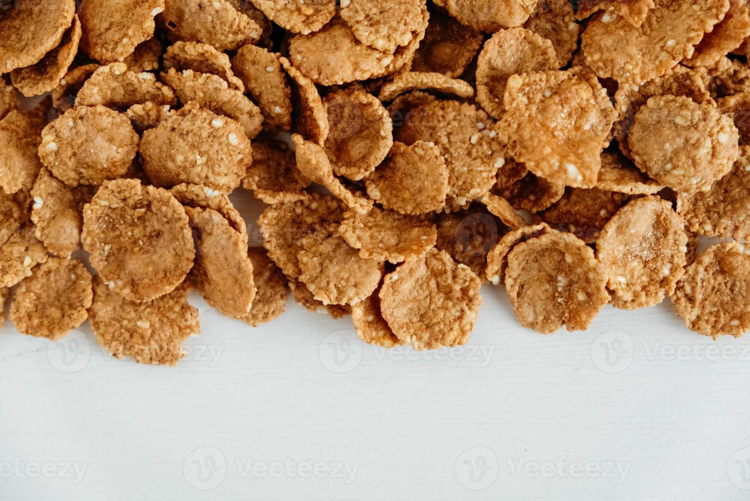 Crispy healthy dry cereal flakes on white background photo