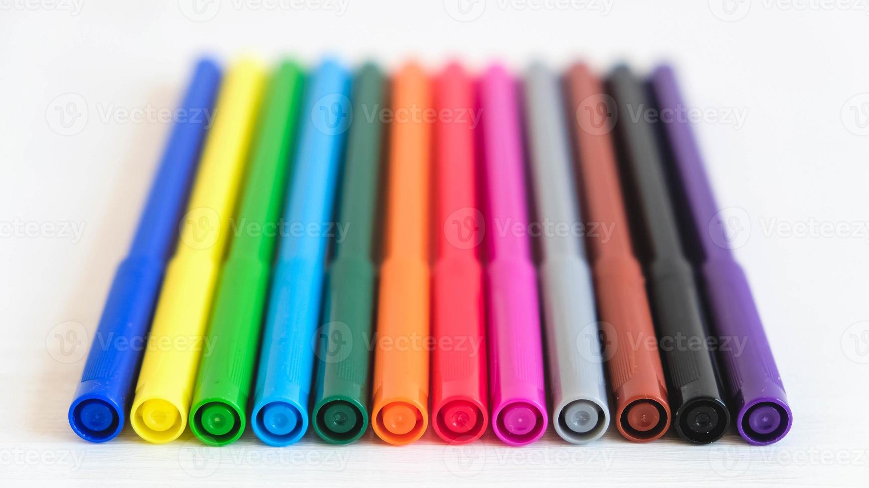 Multicolored felt-tip pens on a white background photo