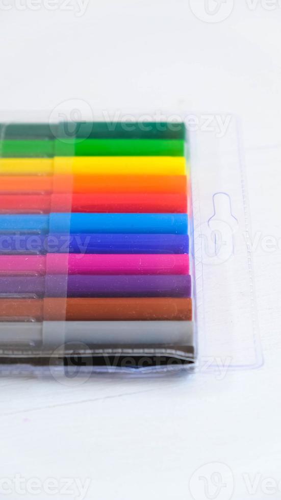 Colored felt-tip pens in a transparent package on a white background photo