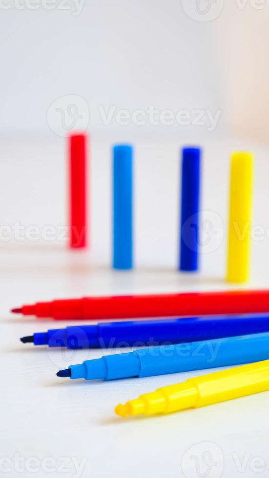 Multicolored felt-tip pens on a white background photo