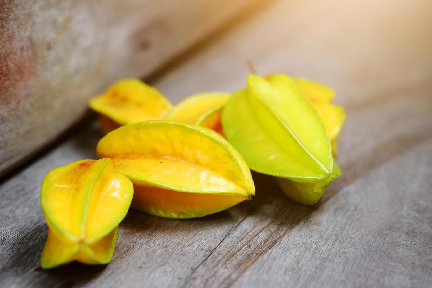 Ripe Yellow star fruit or star apple, Carambola on Wood floor photo