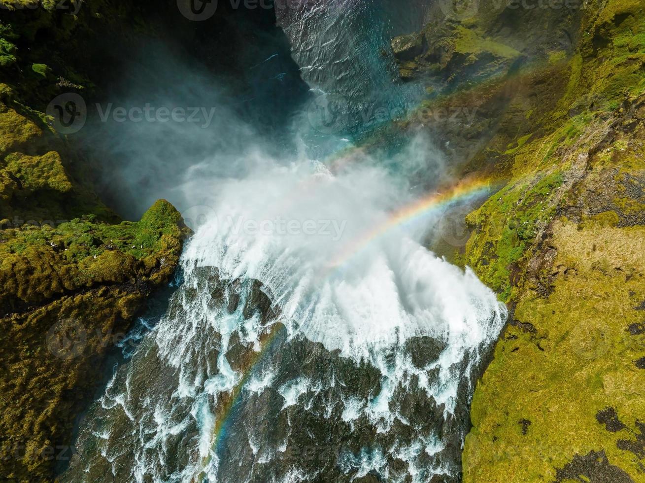 Famous Skogafoss waterfall with a rainbow. Dramatic Scenery of Iceland during sunset. photo