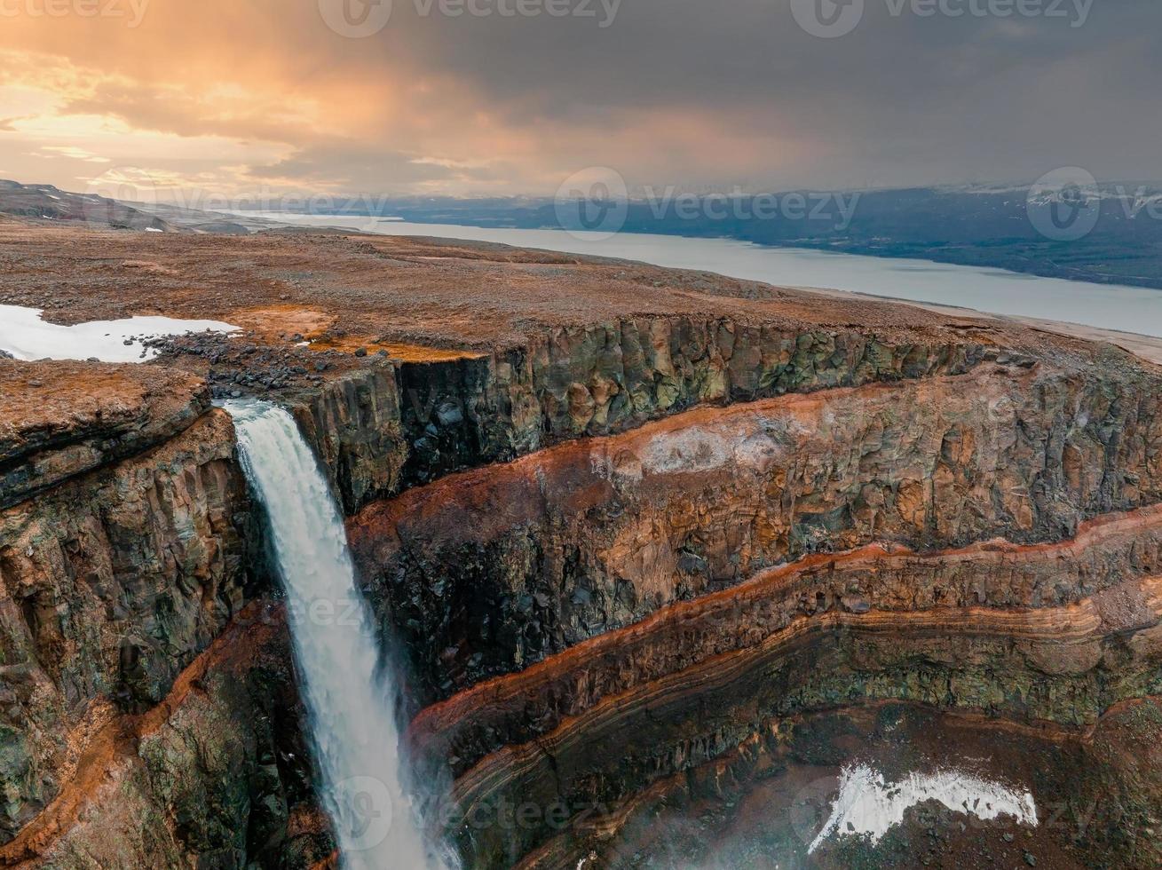 Aerial view on Hengifoss waterfall with red stripes sediments in Iceland. photo