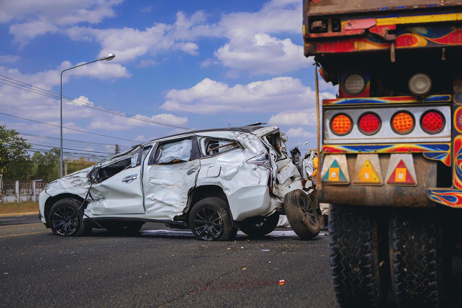 Car crash dangerous accident on the road. SUV car crashing damaged by another one on the road waiting for rescue. photo