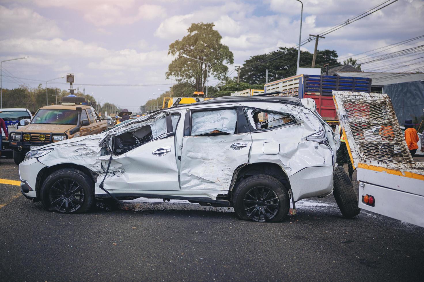 Car crash dangerous accident on the road. SUV car crashing damaged by another one on the road waiting for rescue. photo