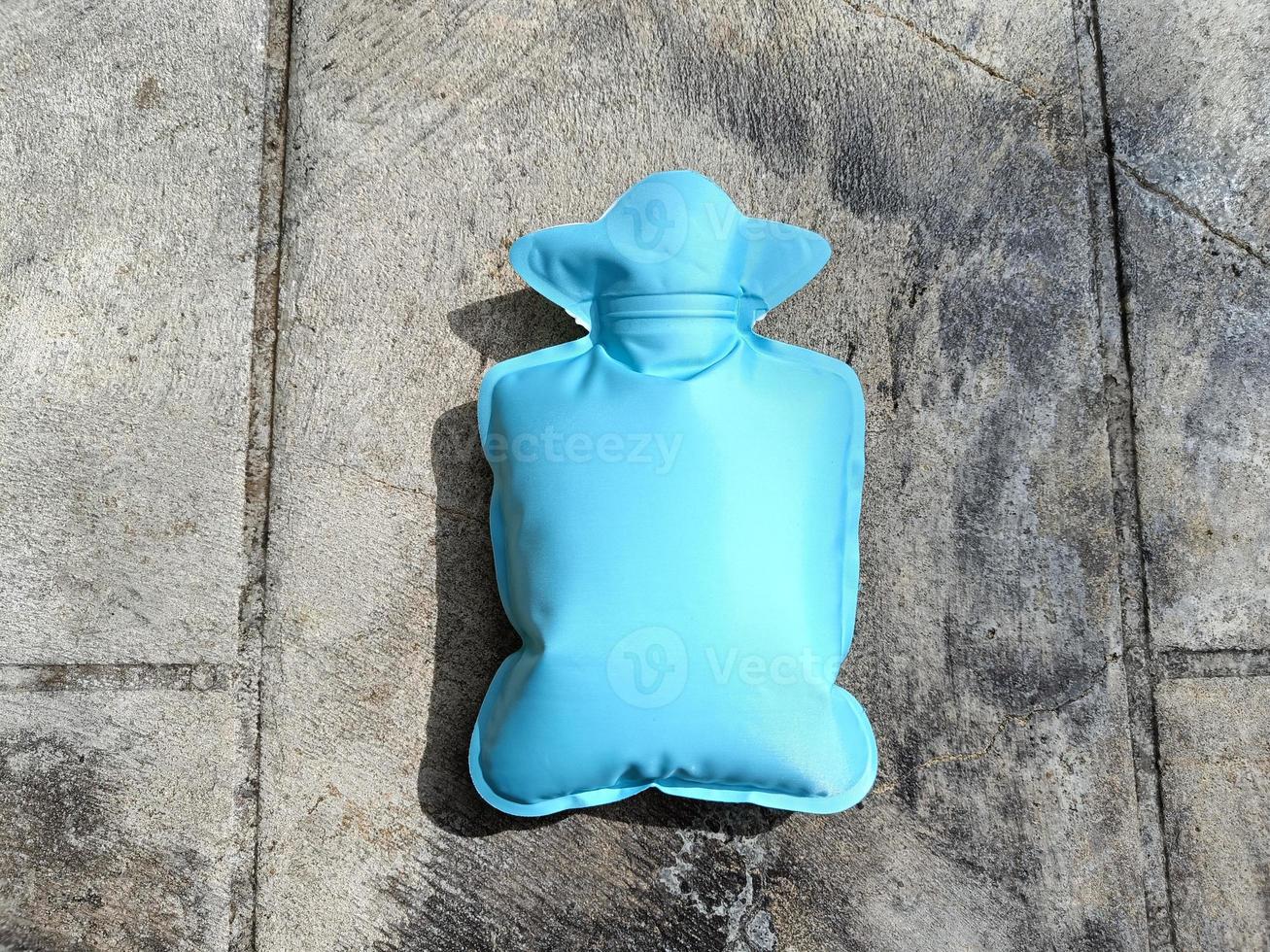 green or mint hot water bottle or bag for relieving menstrual pain photo