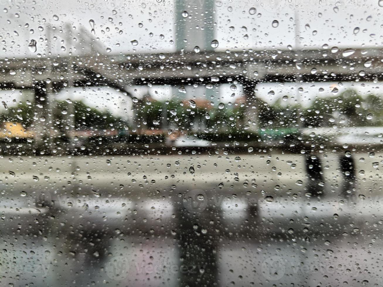 Rain drops on window glass surface. Rainy background photo