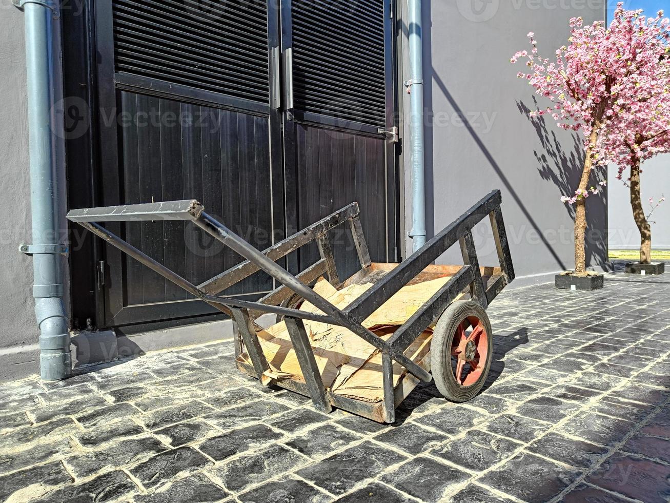 small old black cargo cart midday sunlight photo