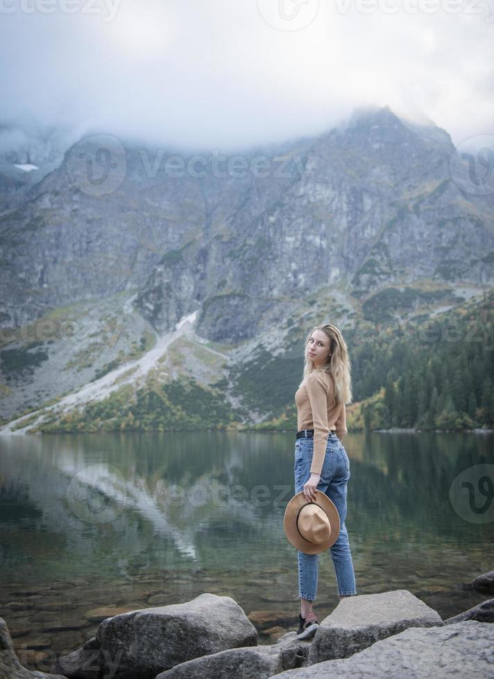 Young woman  travelling at lake in forest. photo