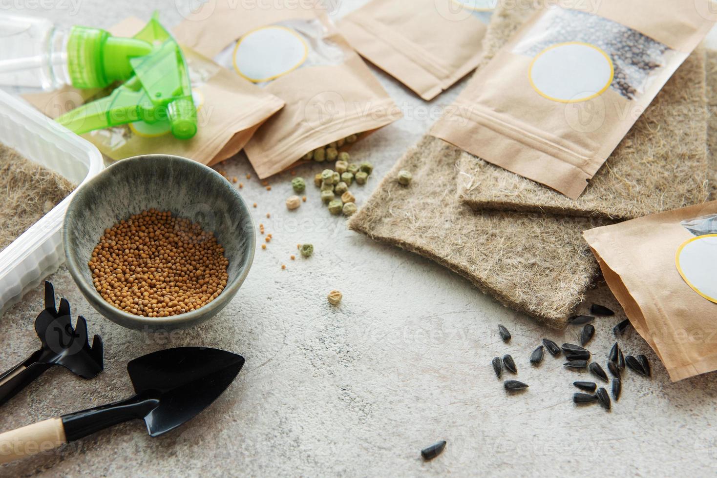 Microgreen seeds in paper bags and equipment for sowing microgreens. photo