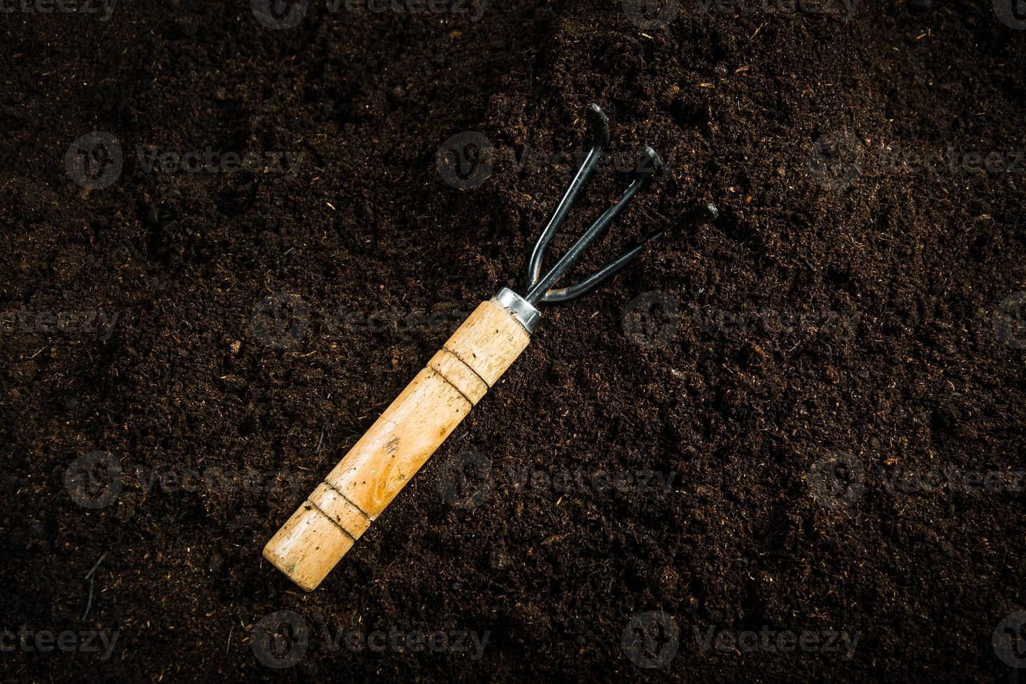 Gardening equipment and hand with soil photo