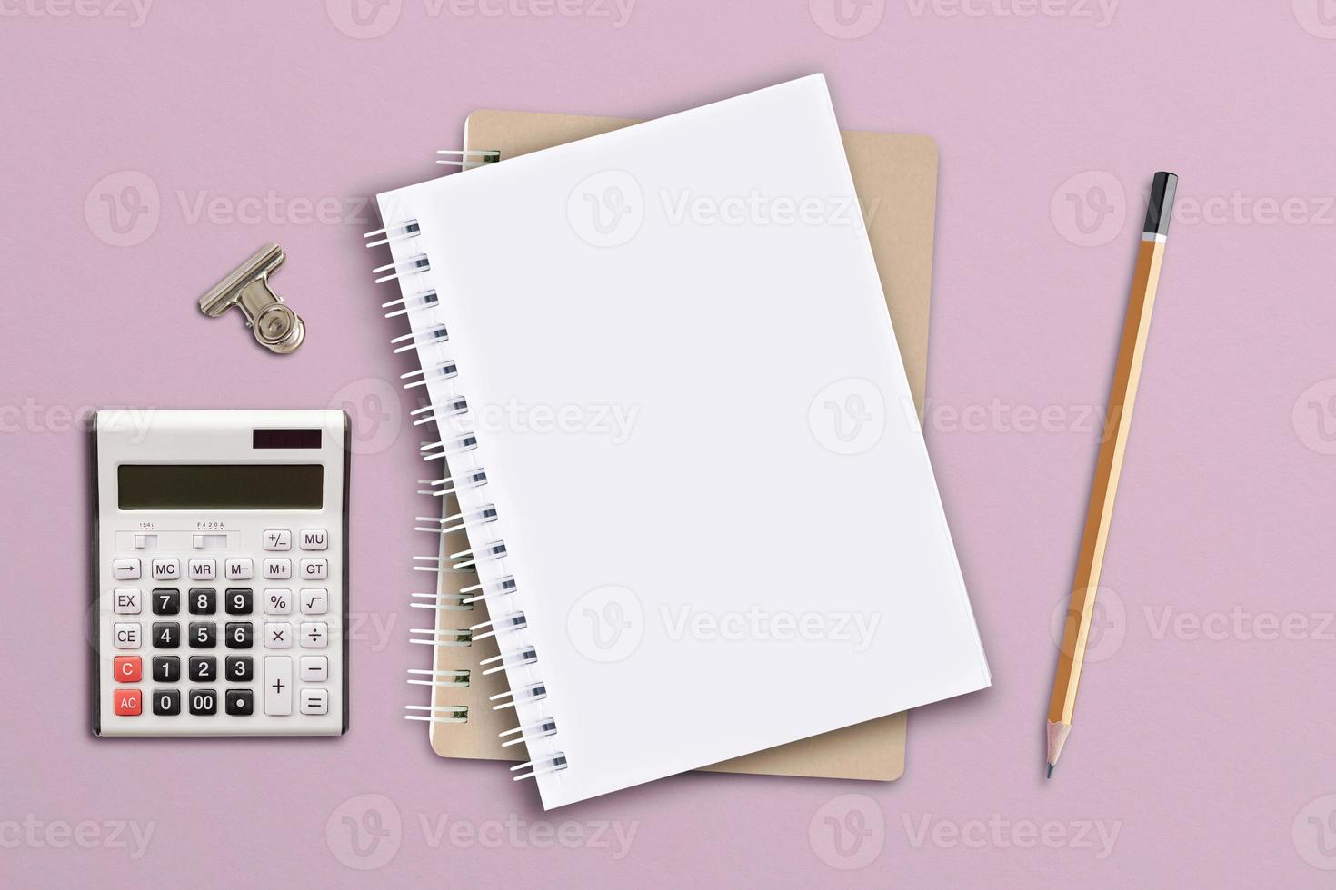 Notebook is located on a pink paper background. photo