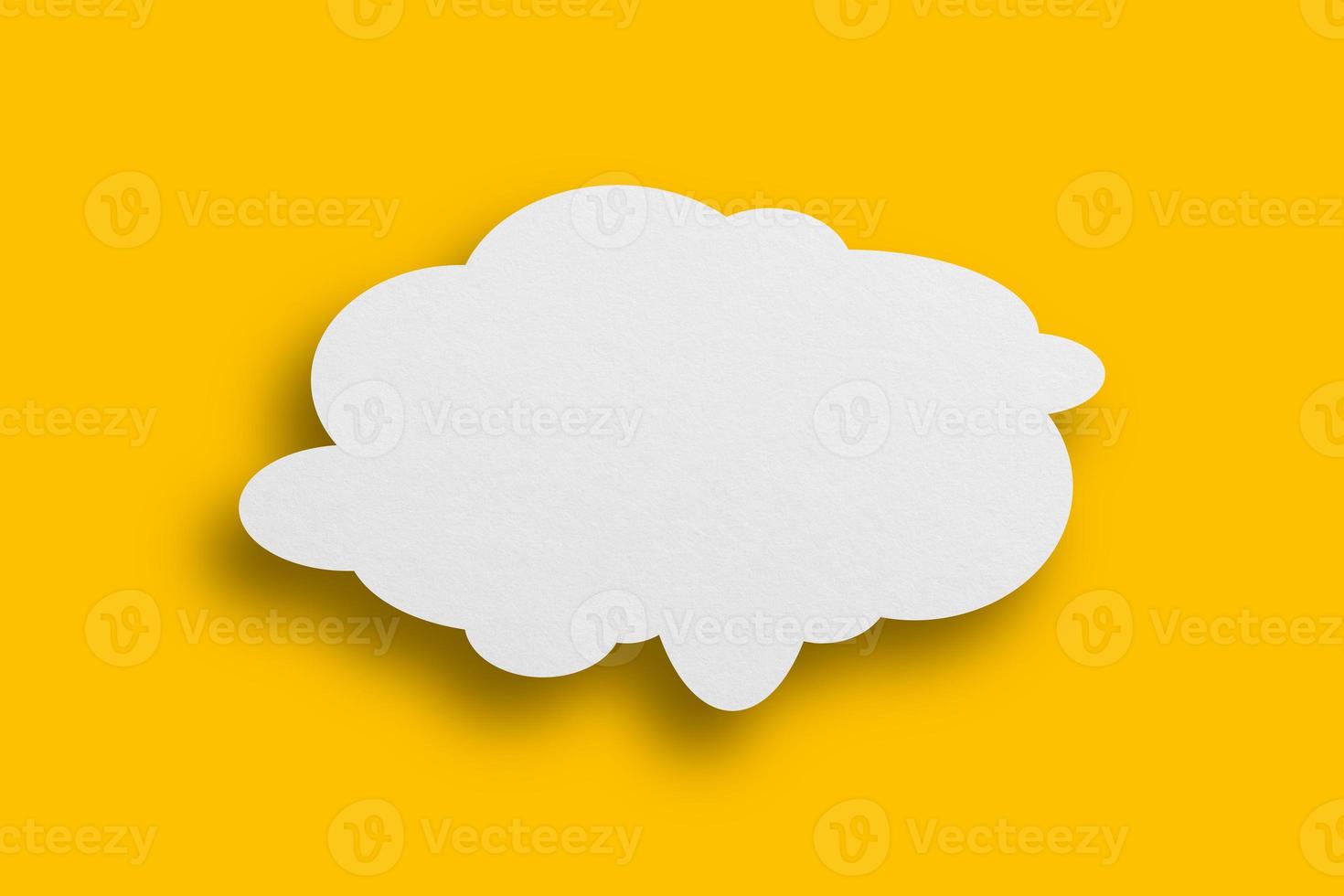 White paper in speech bubble shape set against yellow background. photo