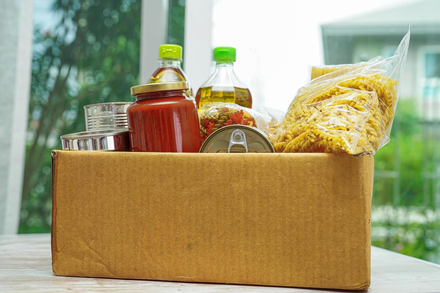Foodstuffs in donation box for volunteer. photo