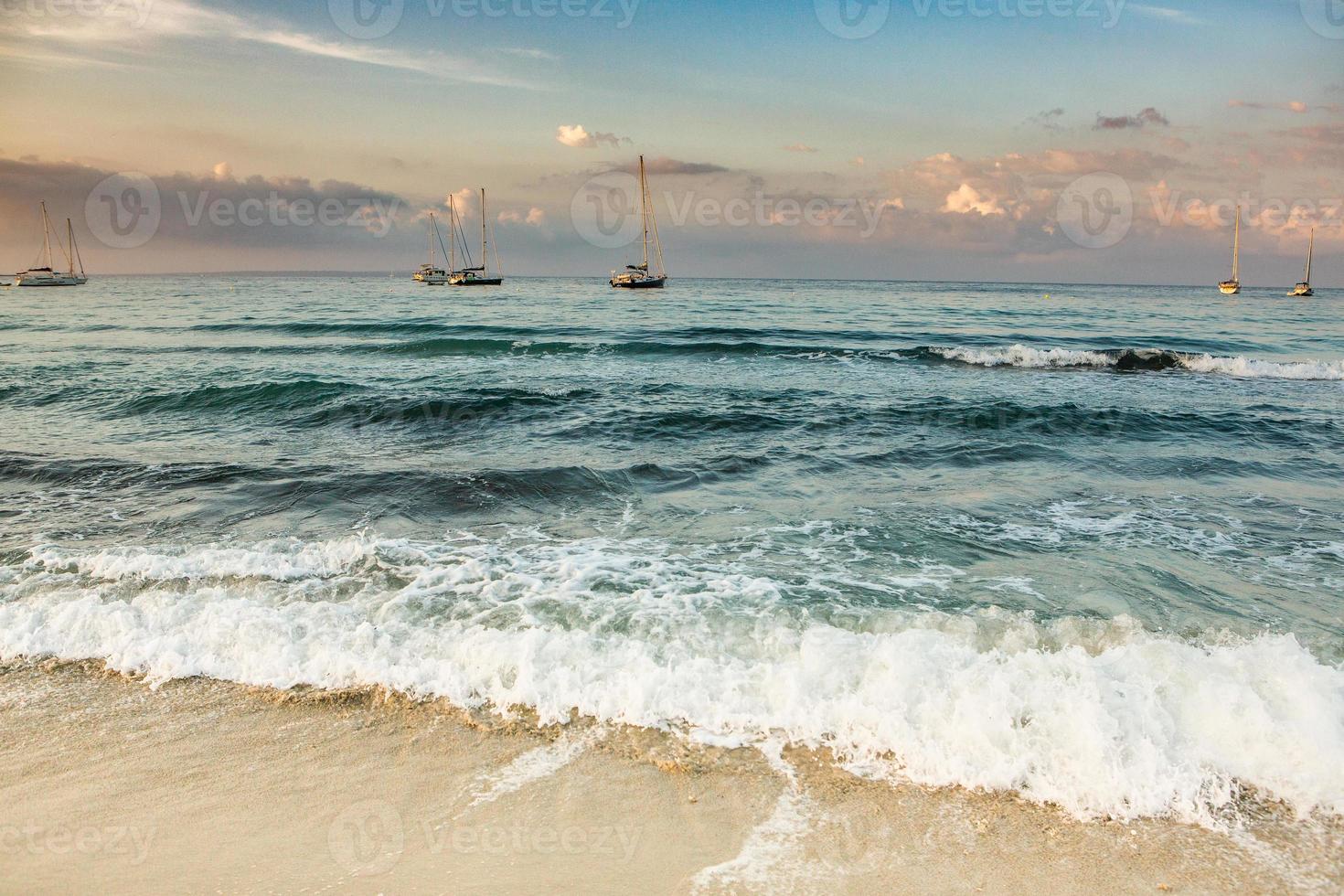 Beautiful beach with very clean and azure water on the mediterranean sea in the island of Ibiza, Spain. photo