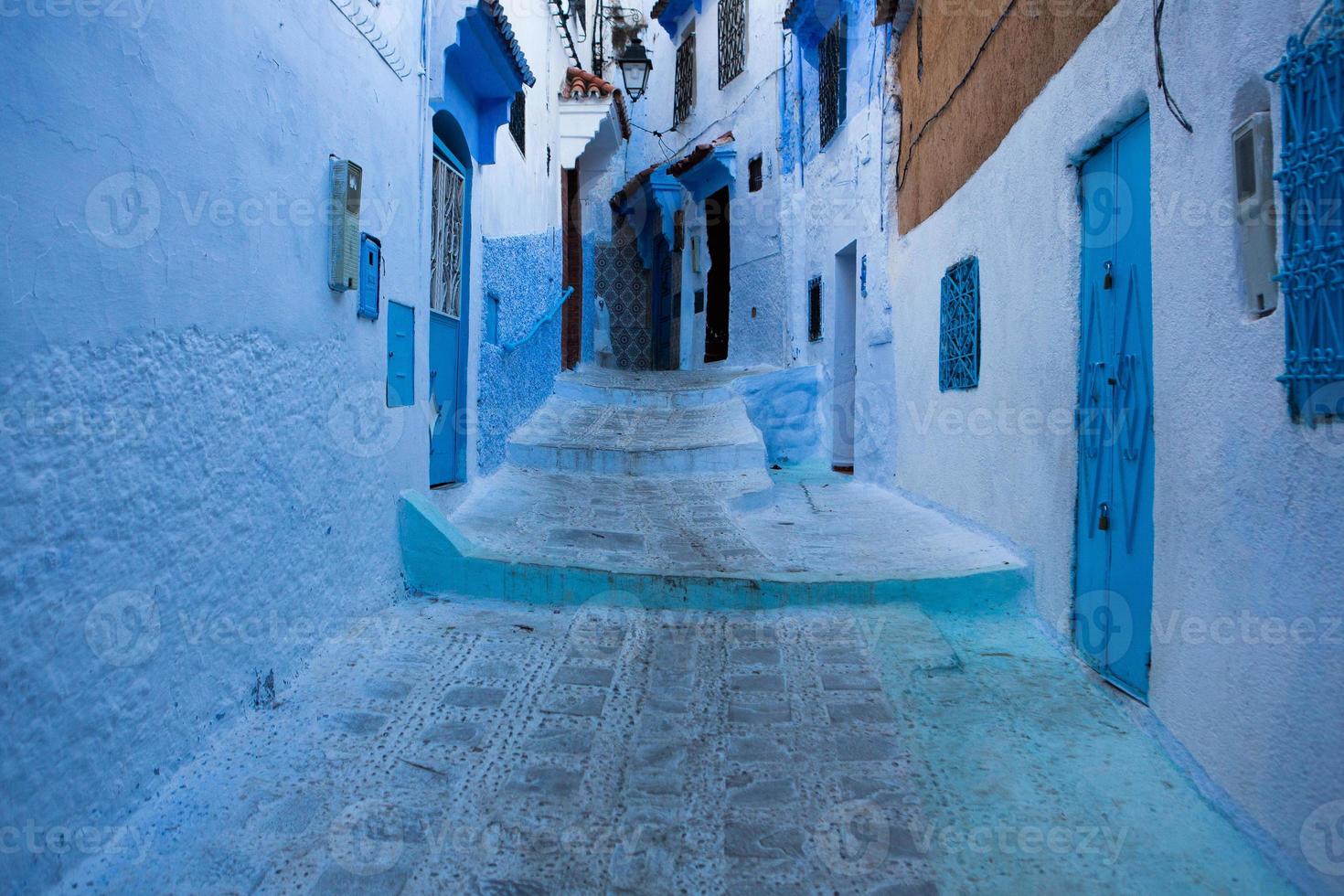 Blue street and houses in Chefchaouen, Morocco. Beautiful colored medieval street painted in soft blue color. photo