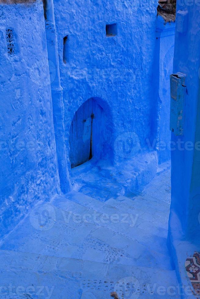 Blue street and houses in Chefchaouen, Morocco. Beautiful colored medieval street painted in soft blue color. photo