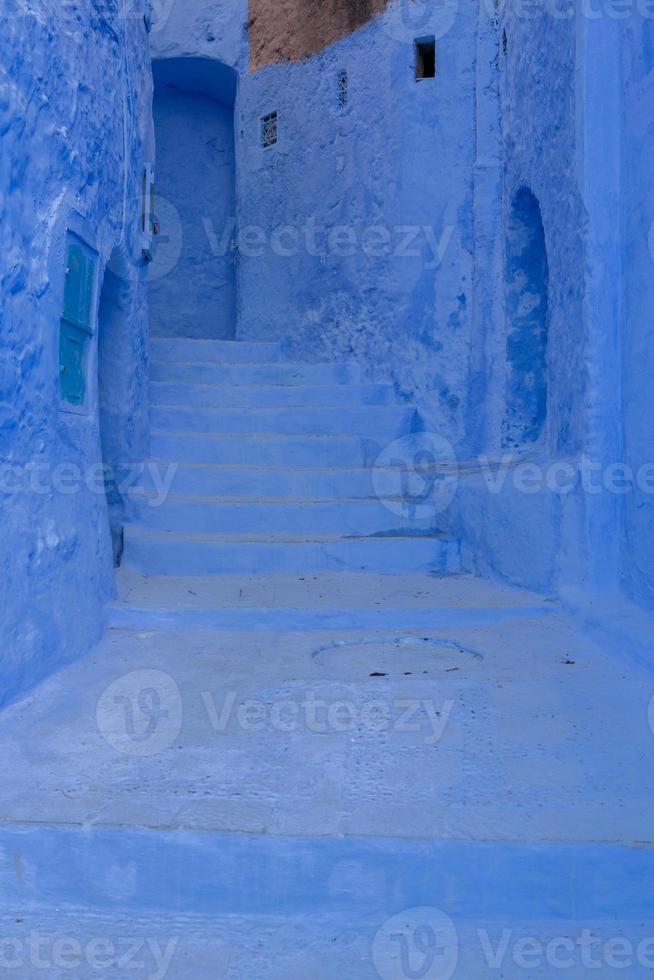 Blue street and houses in Chefchaouen, Morocco. Beautiful colored medieval street painted in soft blue color. photo