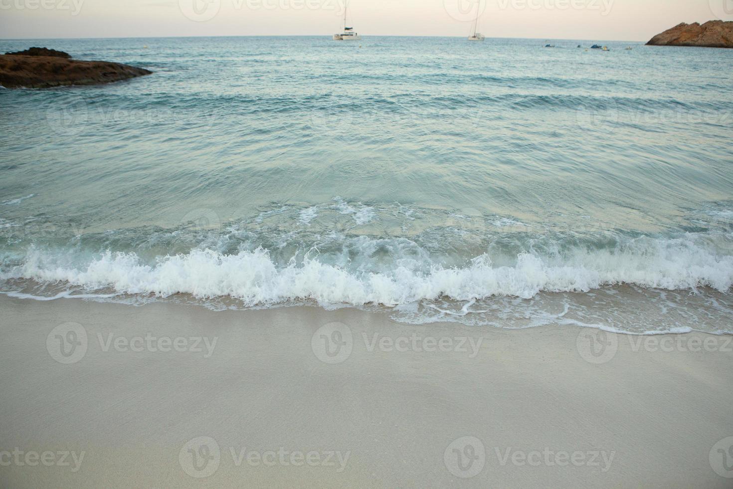 Beautiful beach with very clean and azure water on the mediterranean sea in the island of Ibiza, Spain. photo