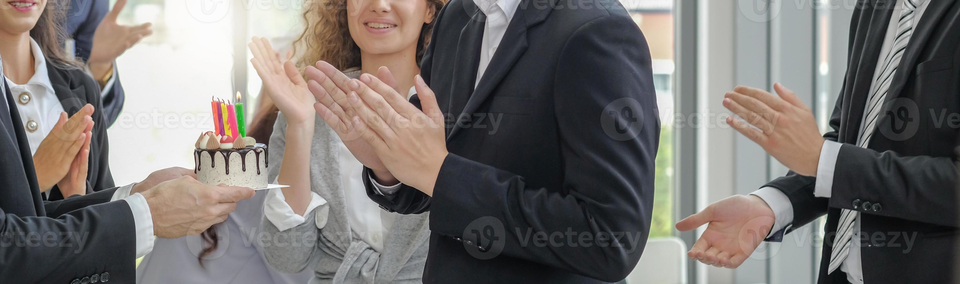 Diversity business people surprise birthday to colleague with happy smiling faces, selective focus and light effect. Banner background. photo
