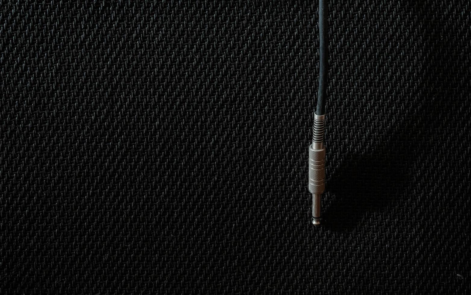 Guitar jack with nature light and shadow on amplifier background at studio, copy space. photo